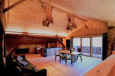a large living room with a table and chairs at Haidnerhof in Bressanone
