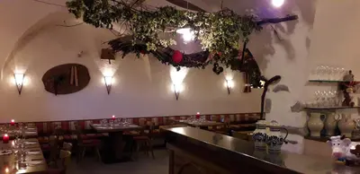 a restaurant with a bar with tables and chairs at Haidnerhof in Bressanone