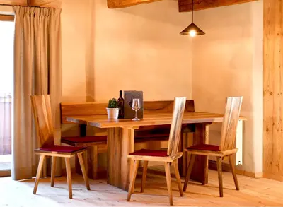 a dining room with a wooden table and chairs at Haidnerhof in Bressanone
