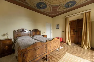 a bedroom with a wooden bed and a coffered ceiling at Casa Bolego in Cagnò