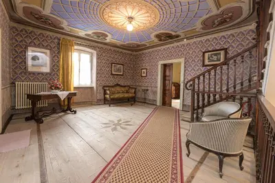 a living room with a staircase and a ceiling at Casa Bolego in Cagnò
