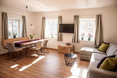 a living room with a table and a couch at Puenlandhof in Brunico