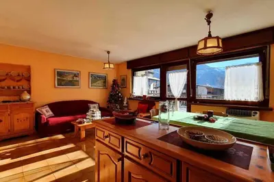 a living room with a couch and a table at Dolomiti Terrace Cavalese in Cavalese