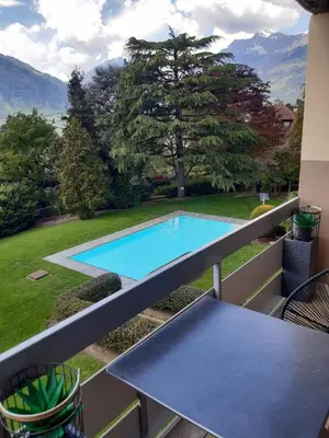 a swimming pool on the balcony of a house at Appartement Pienzenau in Merano