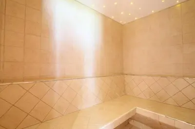 a large room with a large tiled floor and avisor at Gasthof Albergo Neuwirt in Val di Vizze