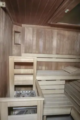 a sauna with a stove in a wooden room at Gasthof Albergo Neuwirt in Val di Vizze