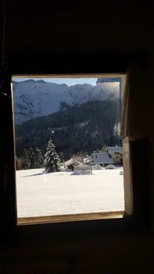 two pictures of a house in the snow at App G&G in Sagron Mis