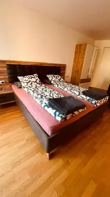 a large bed in a room with a wooden floor at Appartement Nadia in Bressanone