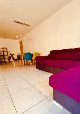 a living room with a couch and a table and chairs at Appartement Nadia in Bressanone