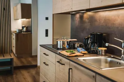 a kitchen with a sink and a counter top at Guesthouse Karnatsch in Parcines