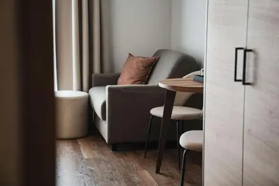 a living room with a couch and a table at Guesthouse Karnatsch in Parcines