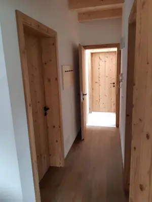 a hallway with two doors and a window at Nestlhof in Vipiteno