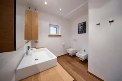 a bathroom with a sink and a toilet and a shower at Apartment Steinach in Lagundo