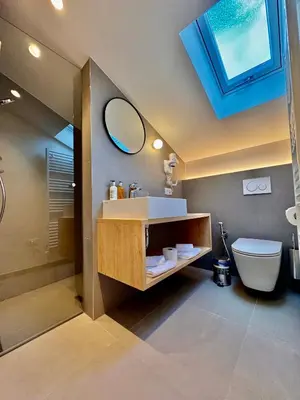 a kitchen with white cabinets and stainless steel appliances at Apartment Steinach in Lagundo
