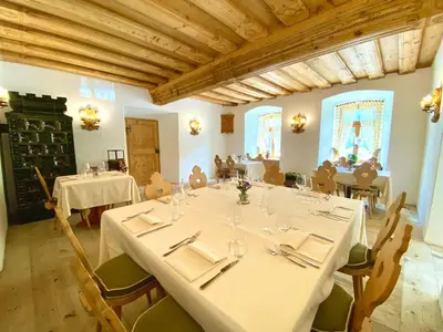 a dining room with white tables and chairs and a ceiling at Rifugio Ospitale in Cortina dʼAmpezzo