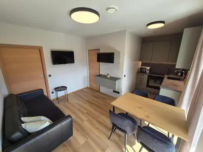 a living room with a couch and a table at Appartement Mayr in Parcines