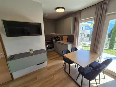 a room with two yellow chairs and a bunk bed at Appartement Mayr in Parcines
