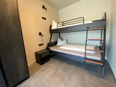 a bedroom with two bunk beds with a ladder at Appartement Mayr in Parcines