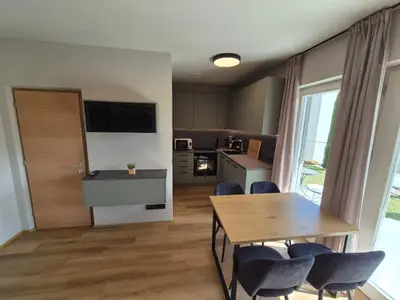 a kitchen and dining room with a table and chairs at Appartement Mayr in Parcines