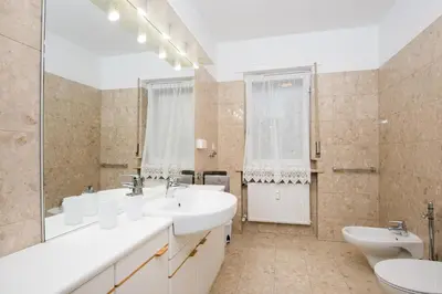 a bathroom with two sinks and two toilets at Casa Adriana in Bressanone
