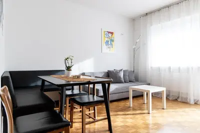 a living room with a table and a couch at Casa Adriana in Bressanone