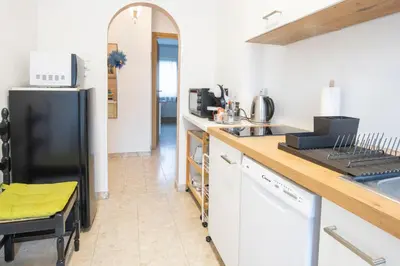 a kitchen with a black refrigerator and a counter at Casa Adriana in Bressanone
