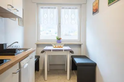 a small kitchen with a table and a window at Casa Adriana in Bressanone
