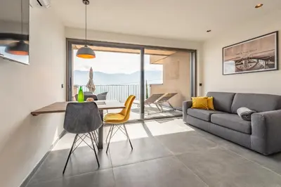 a living room with a couch and a table and chairs at Apfelhof in Termeno