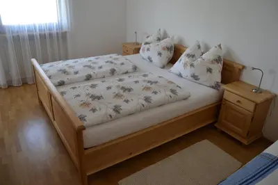 a bedroom with a large bed with white sheets and pillows at Apartment Lukas Huber in Brunico