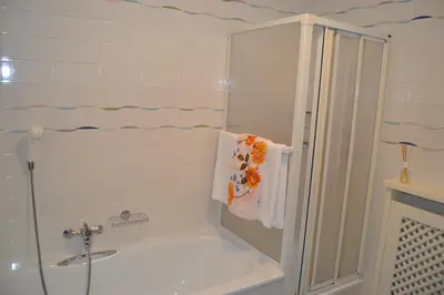a bathroom with a shower and a tub and a sink at Apartment Lukas Huber in Brunico
