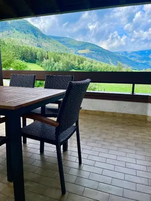 a table and chairs on a balcony with a view at Apartment Lukas Huber in Brunico
