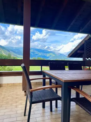 a table and chairs on a balcony with a view at Apartment Lukas Huber in Brunico