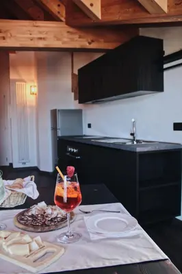 a kitchen with a table with a wine glass on it at SAN ROMEDIO Agriturismo in Romeno