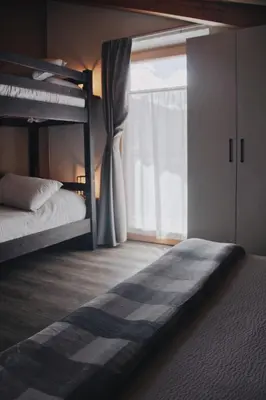 a bedroom with two bunk beds and a window at SAN ROMEDIO Agriturismo in Romeno