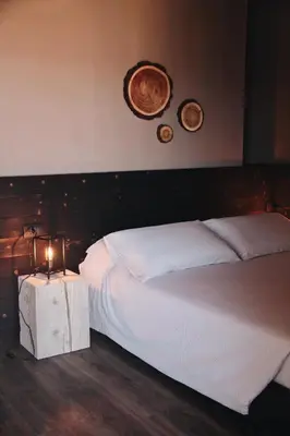 a bedroom with a bed and two plates on the wall at SAN ROMEDIO Agriturismo in Romeno