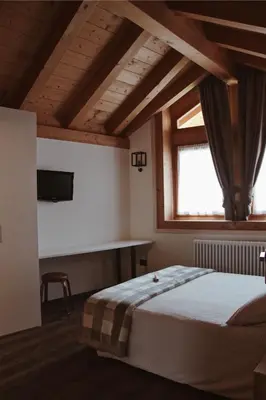 a bedroom with a large bed and a window at SAN ROMEDIO Agriturismo in Romeno