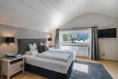 a window with a view of a snow covered mountain at Picenin 61 Lodging in La Villa
