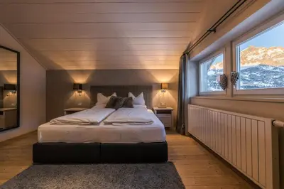 a bedroom with a large bed and a skylight at Picenin 61 Lodging in La Villa