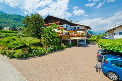 a house with a car parked in front of it at Hotel & Residenz Traubenheim in Nalles