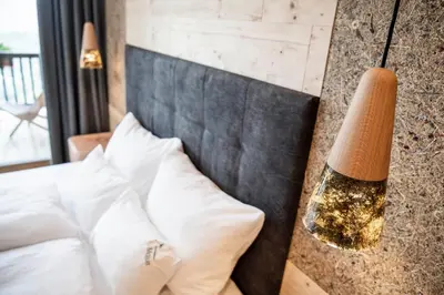 a bedroom with a large bed and a large window at La Majun Fornellahof in Antermoia