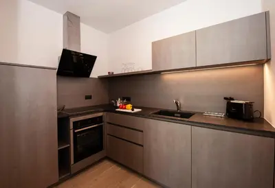 a kitchen with a sink and a stove at Modern Living by Nalserhof in Nalles