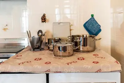 a kitchen counter with pots and pans on a towel at Dimora al Portico Cloz OSPITAR in Cloz