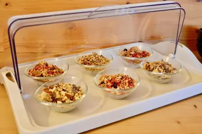a tray filled with bowls of food on a table at Agritur Fiore in Fondo