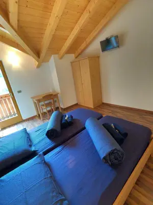 a large blue bed with pillows in a room at Agritur Fiore in Fondo