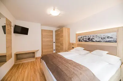 a living room with a couch and a table at Apartments Sosaslong in Selva di Val Gardena