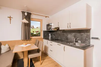 a bathroom with a sink and a shower at Apartments Sosaslong in Selva di Val Gardena