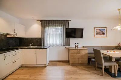 a bathroom with a sink and a shower at Apartments Sosaslong in Selva di Val Gardena