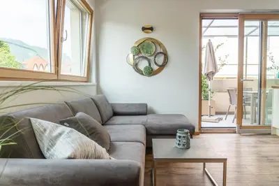 a living room with a couch and a table at Ferienwohnung mit Garage, Fahrradraum und sehr großer sonnenverwöhnten Terrasse in Lagundo