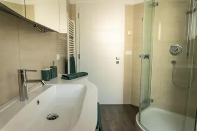 a bathroom with a sink and a tub and a shower at Ferienwohnung mit Garage, Fahrradraum und sehr großer sonnenverwöhnten Terrasse in Lagundo
