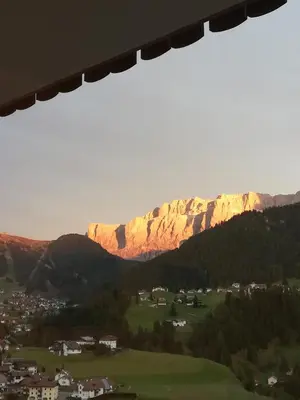 a view of a mountain range with a town and houses at Pension Dolomieu in Santa Cristina in Val Gardena